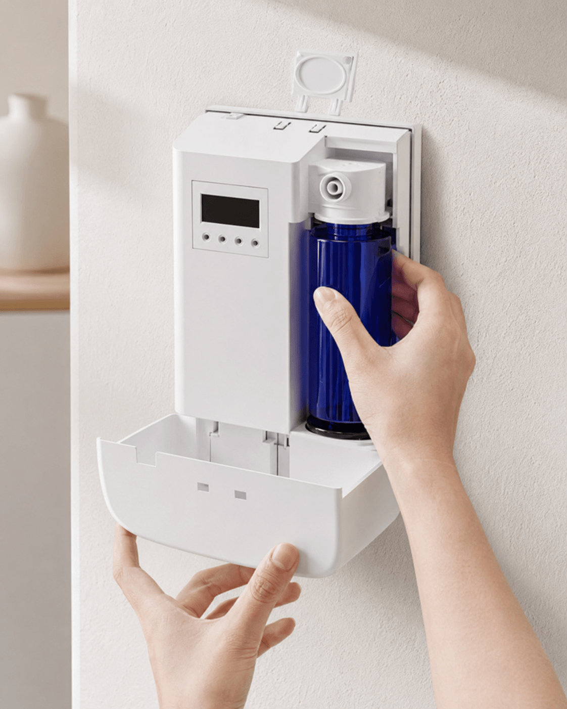 Close-up view of a hand unlocking the sleek SL-01 Commercial Scent Diffuser, revealing a blue fragrance oil bottle and highlighting its secure, easy-access, and space-saving design.