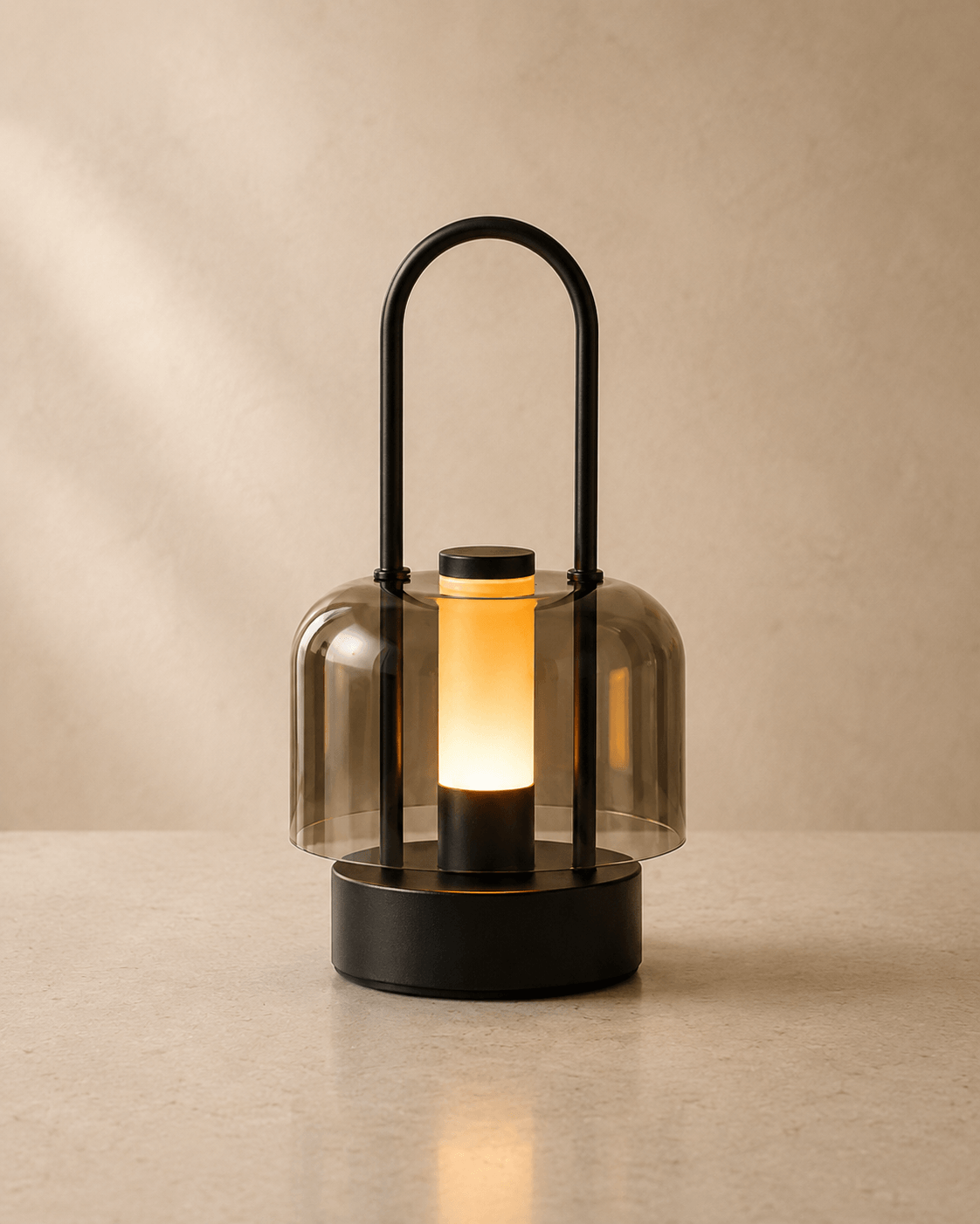 Black portable LED ambient lamp with warm glow and smoked acrylic shade placed on tabletop for indoor home decor
