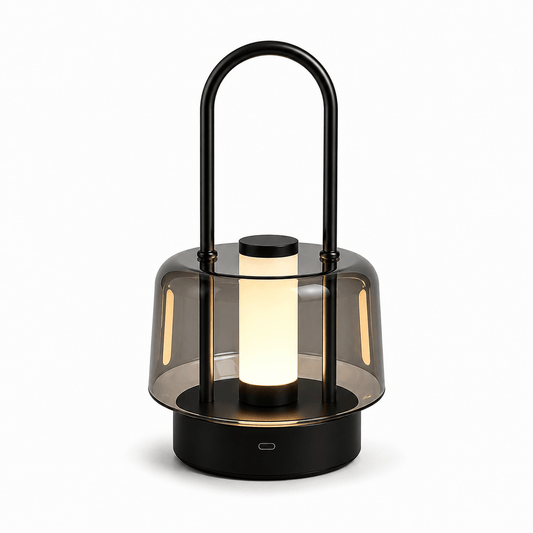 Black portable cordless LED table lamp with metal handle and smoked acrylic shade on white background