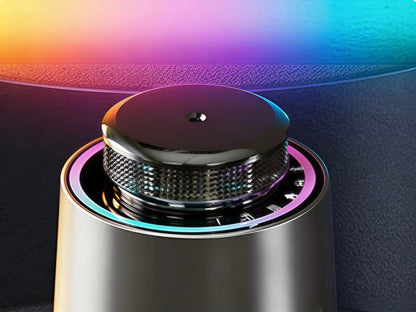 Top view detail of Space Gray StellTails GS-01 car diffuser, showcasing the precision cold-air nozzle surrounded by an ambient RGB light ring and textured aluminum ring.