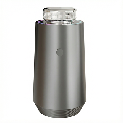 Space Gray StellTails GS-01 smart aluminum car diffuser using waterless cold-air atomization and auto start-stop, placed on dark mesh texture