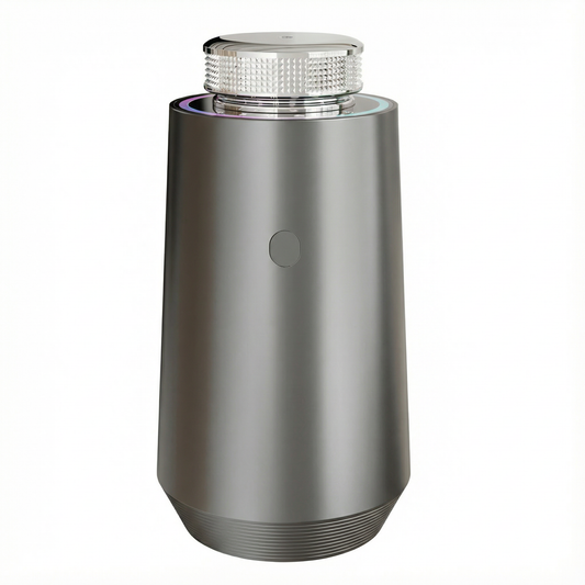 Space Gray StellTails GS-01 smart aluminum car diffuser using waterless cold-air atomization and auto start-stop, placed on dark mesh texture